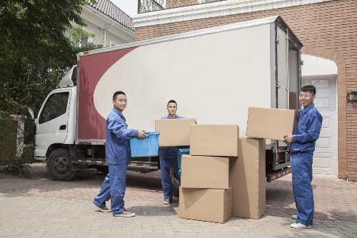 Furniture collection team handling bulky items in a Hounslow residential street